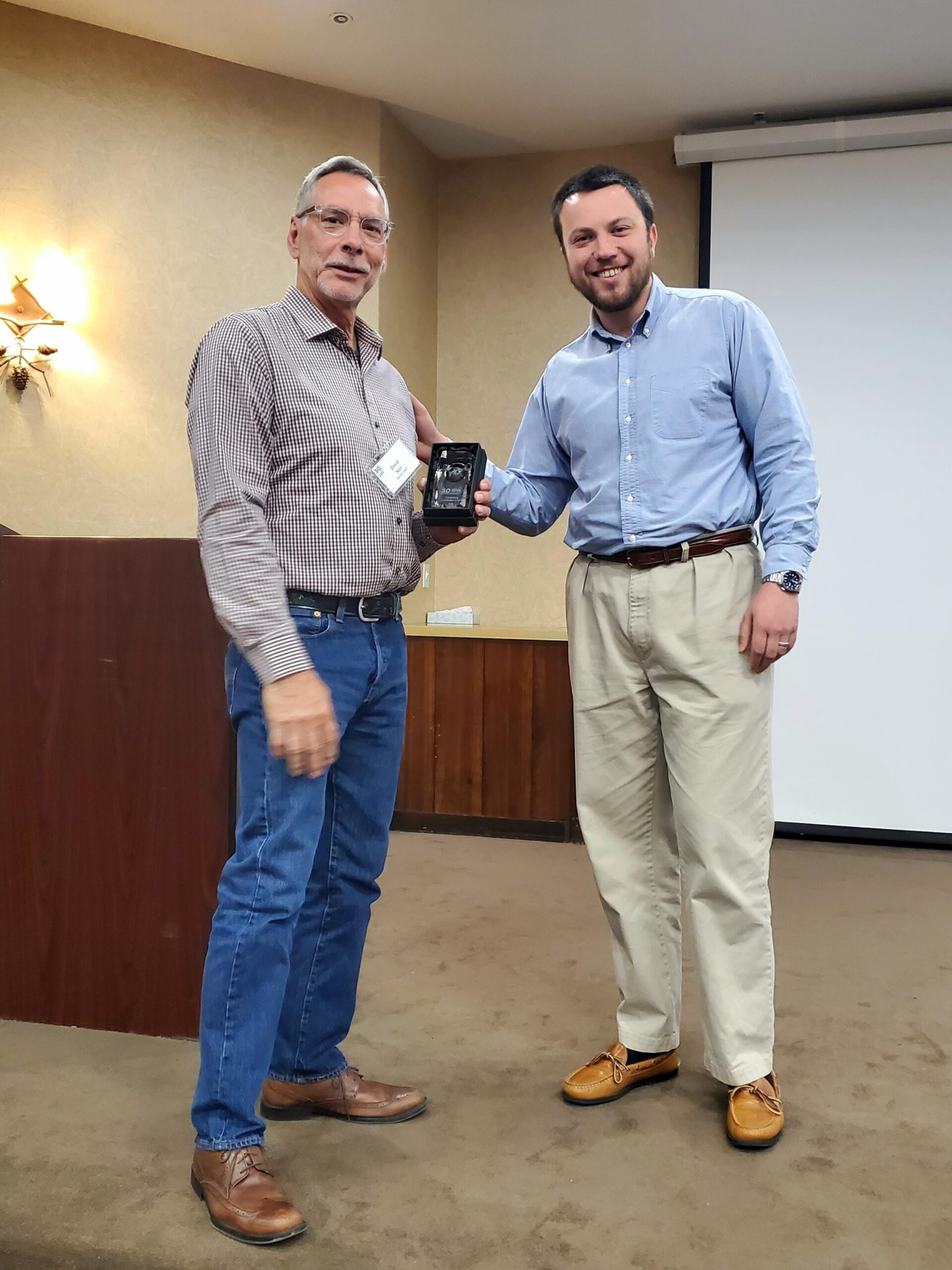 Zack Becker presenting David Nail the Outstanding Contribution to GIS Award for 2025